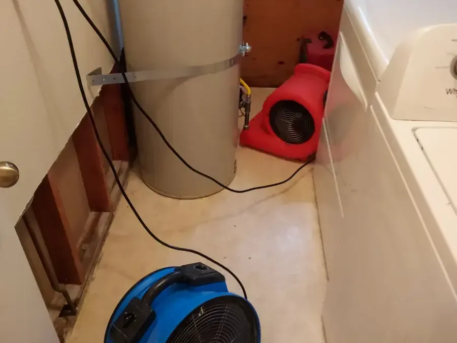 Laundry corner with the wall opened behind the washer and air movers running