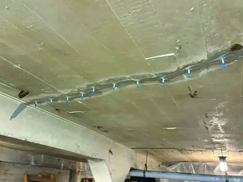 Injection hoses feeding dry air into a ceiling after an overhead leak
